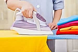 Cleaner Ironing Clothes On Ironing Board